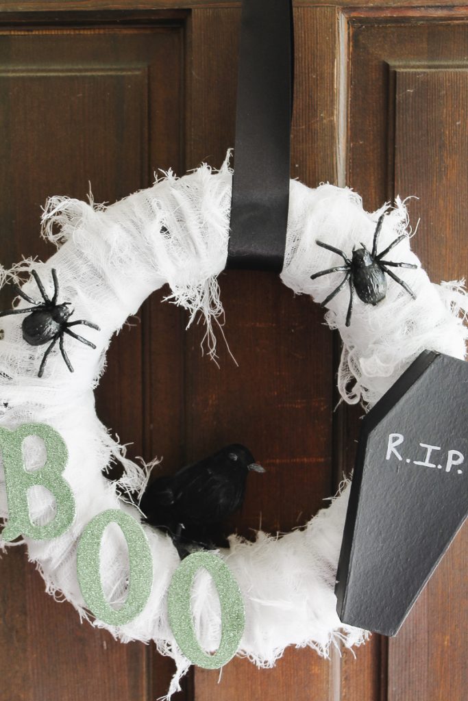 halloween wreath with a coffin on a door