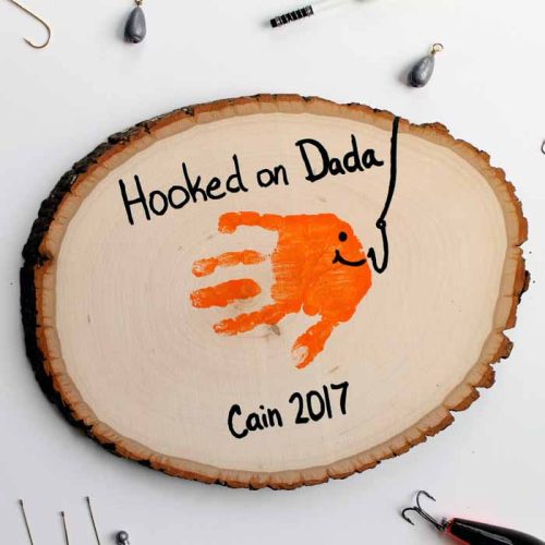 9 Inches & comes with stand. Hooked on dad handprint round. Can