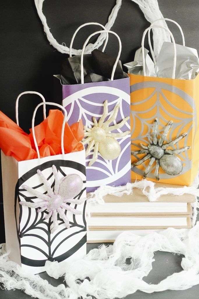 adding spiders to a gift bag for halloween