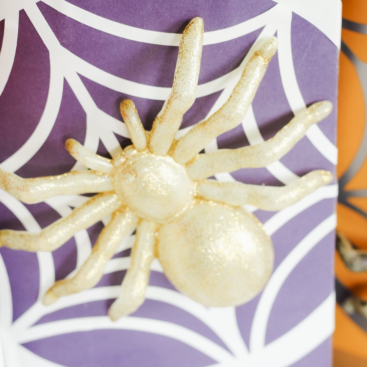 glue plastic spider to a gift bag for halloween