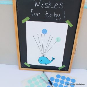 Baby shower guest book idea with free printable whale art! Turn this fun guest book into art for baby's nursery after the shower!