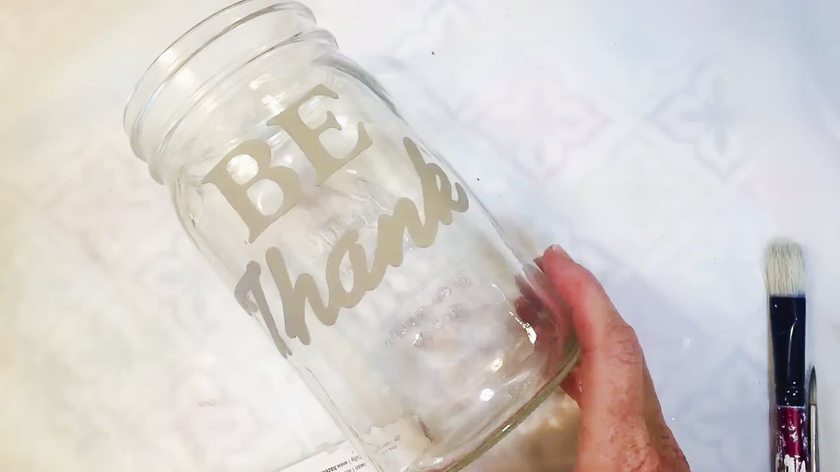 adding stencils to a mason jar