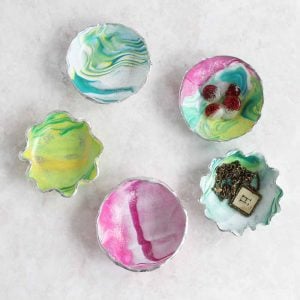 Learn how to make a trinket dish from oven bake clay! These marbled ring bowls make a great gift idea and are perfect for mom!