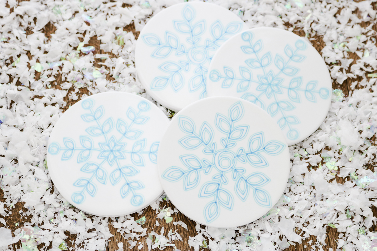 snowflake coasters on a table 