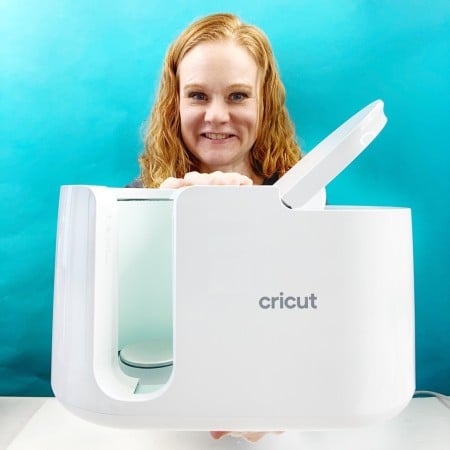 angie holden holding the cricut mug press