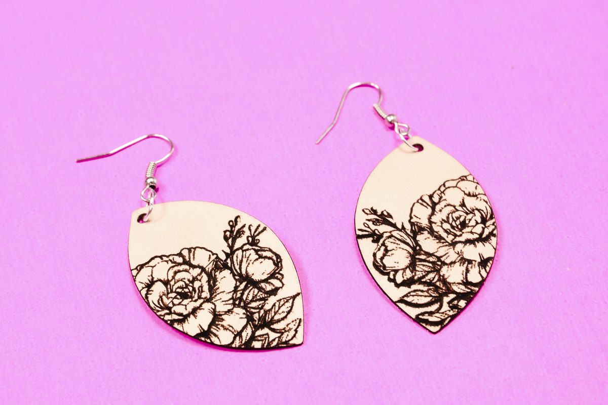 Leather earrings with engraved designs.