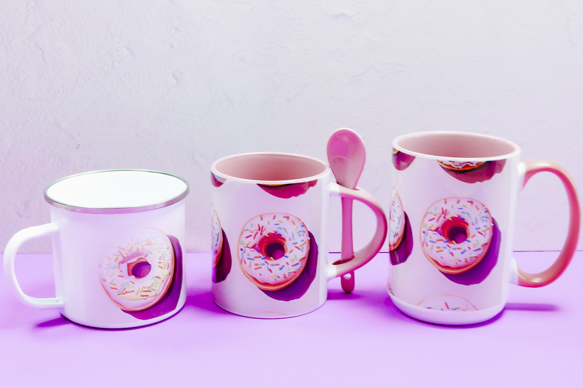 Metal camp sublimation mug, sublimation mug with matching spoon, and sublimation mug with pink handle.