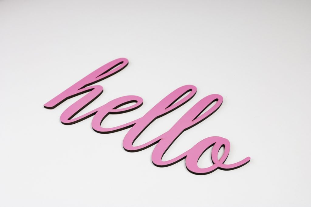 Hello sign cut out of wood with WeCreat Vision.