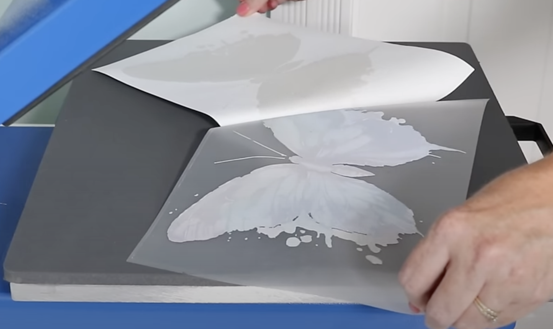 Peel adhesive sheet away from print.