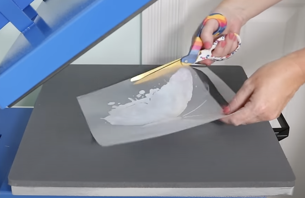 Use scissors to trim around print to remove any adhesive residue.