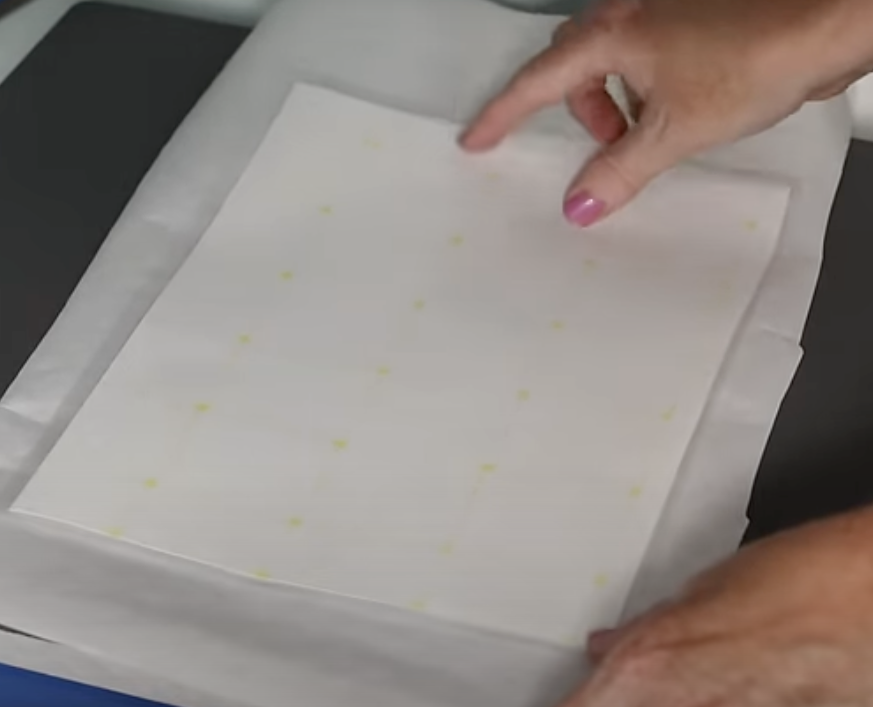 Add adhesive sheet on top of print, adhesive side down.